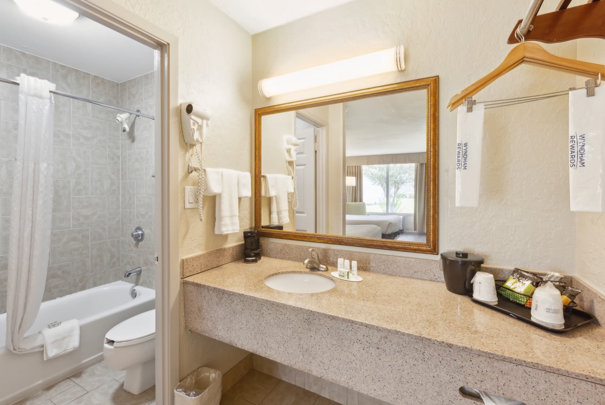 Guest bathroom with a tub-shower, vanity and fresh towels