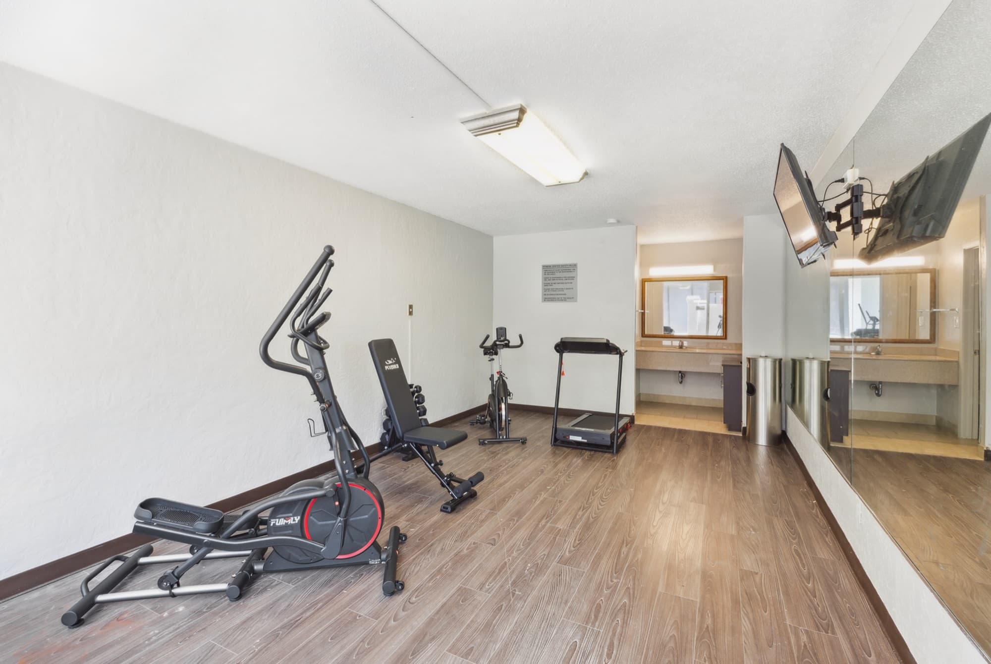 Fitness room with an elliptical, treadmill and exercise bike